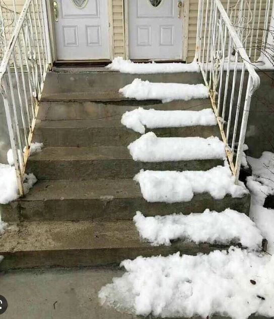 Snow Covers The Steps Of A House, Creating A Serene Winter Scene With A Soft White Blanket