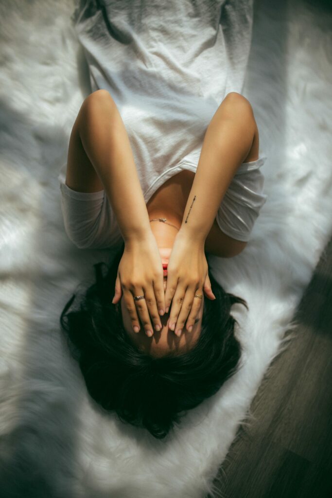 A woman lying on soft white rug