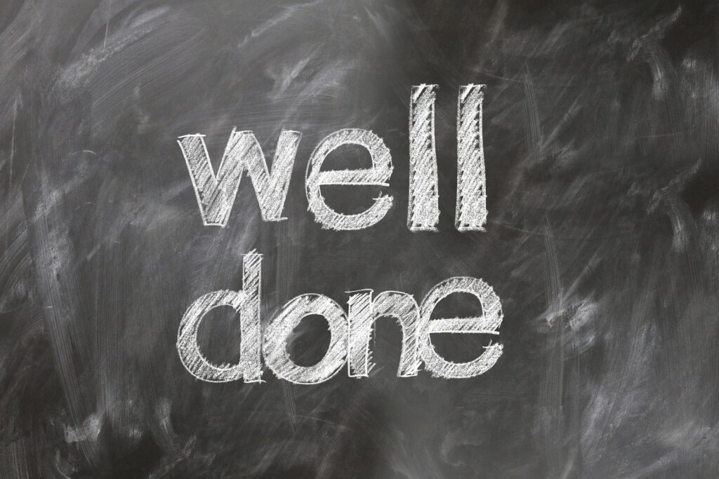 A blackboard with the words "well done" written in white chalk