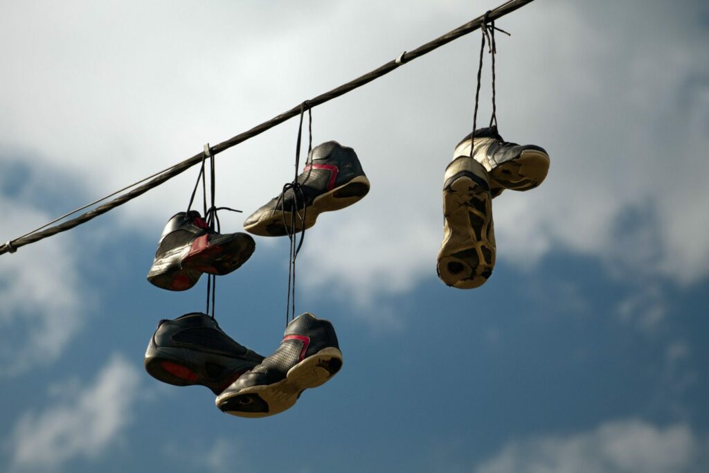 A group of shoes dangling from a wire