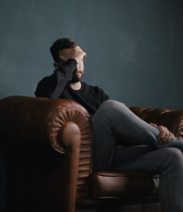 A man sits on a couch