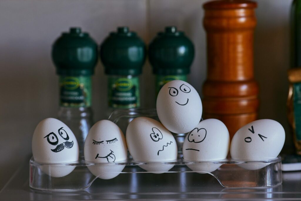 A group of eggs with funny faces drawn on them