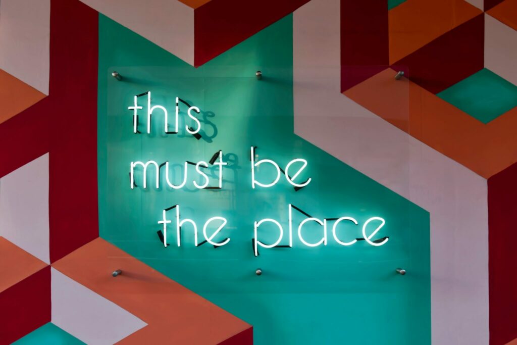 Neon sign that reads "This Must Be The Place"